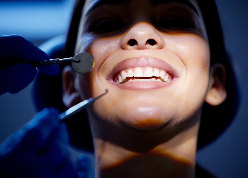 Dentist discussing dental cap replacement options with a patient